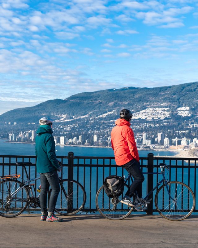 two bicyclists looking towards west Vancouver